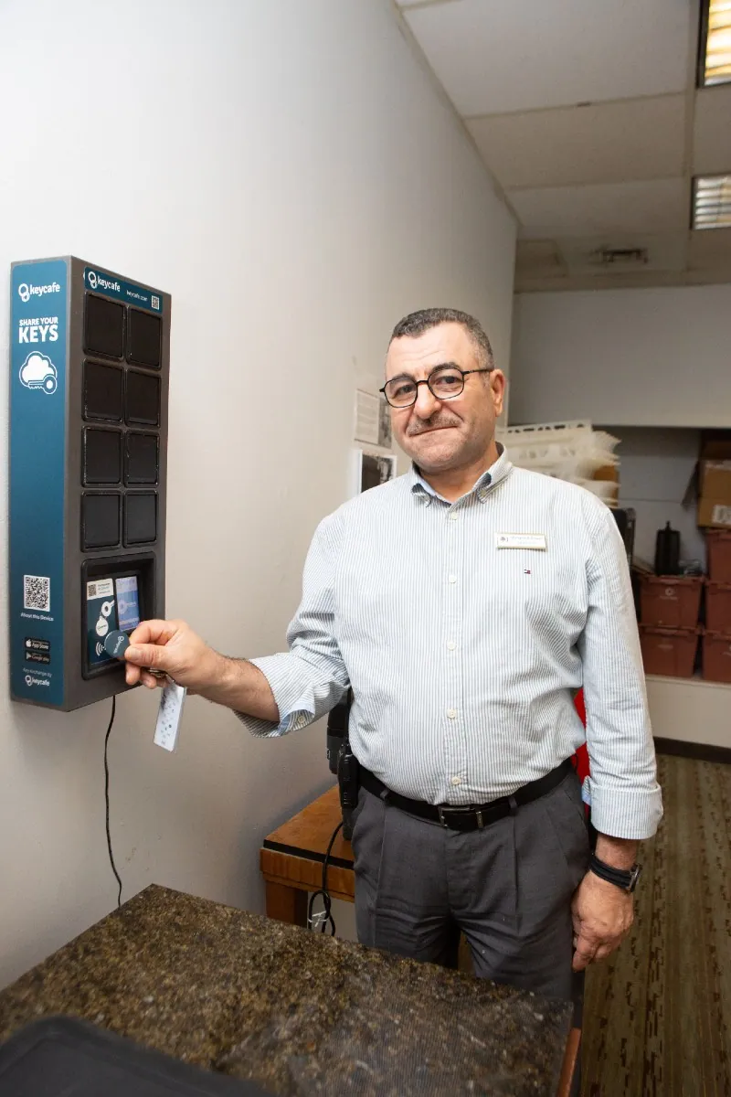 Director of F&B Mohamed Anwer scanning a Keycafe fob at the SmartBox and smiling