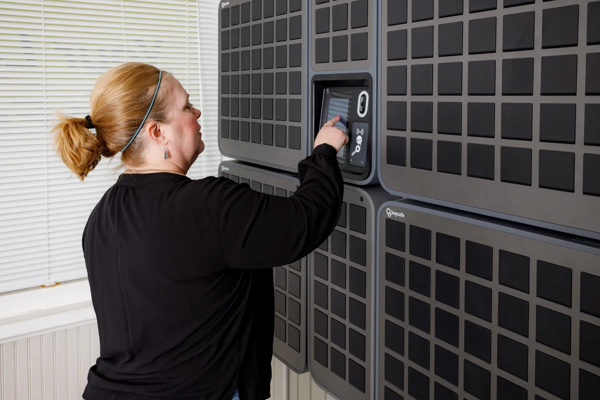 Your Place Property Management employee tapping a SmartBox screen