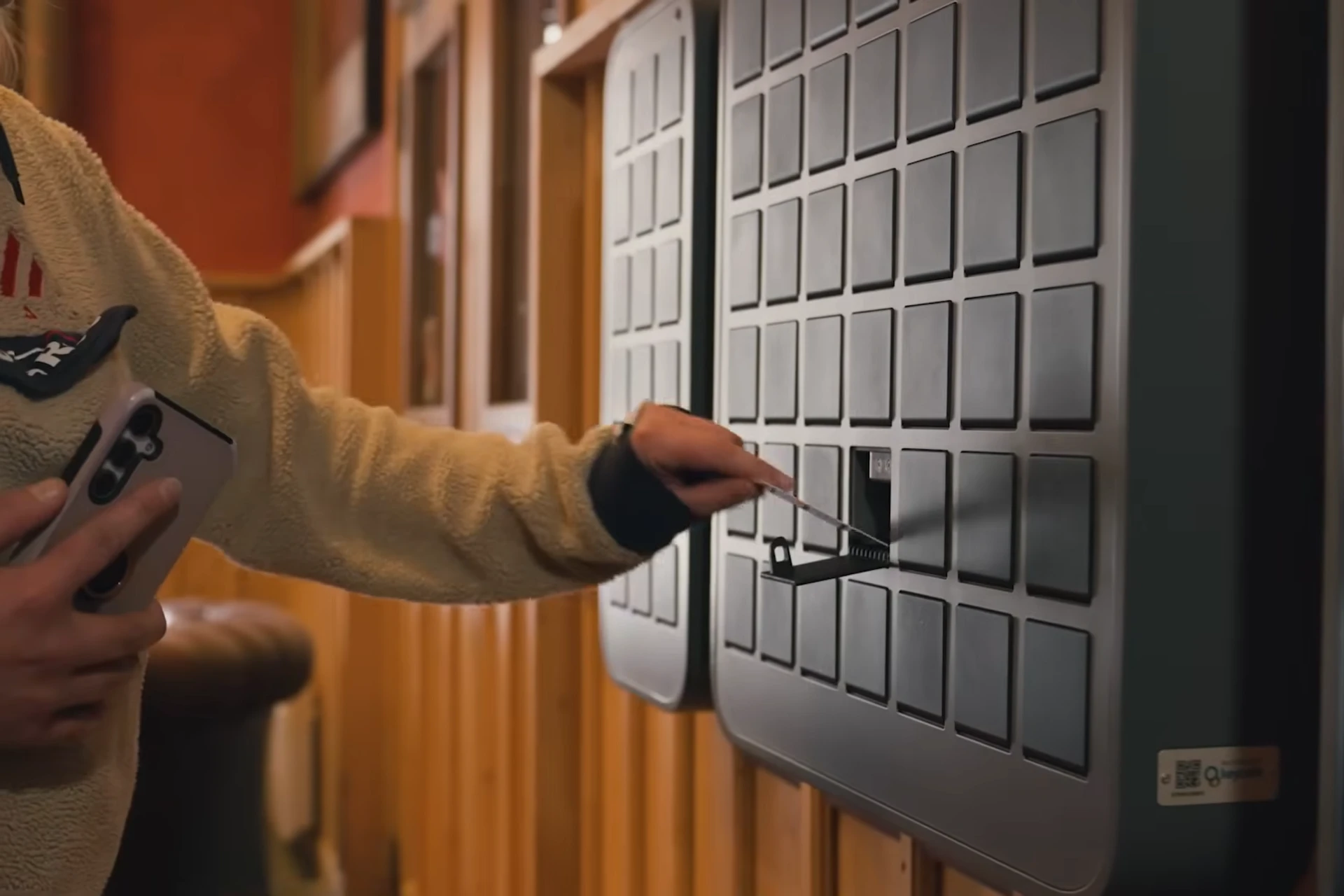 Hotel guest taking a keycard from a SmartBox bin