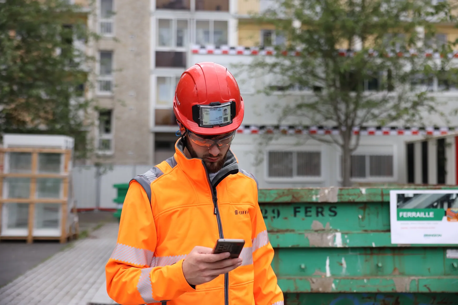 Hugo Peron looking at the Keycafe app on his mobile phone on a construction site