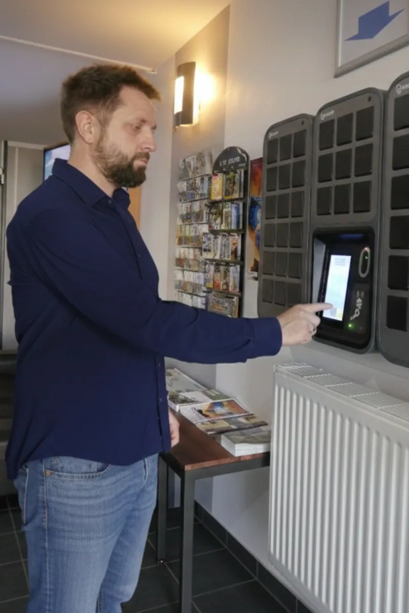Hôtel les Pieux Hotelier Thomas Cadot tippt auf seinen SmartBox-Bildschirm