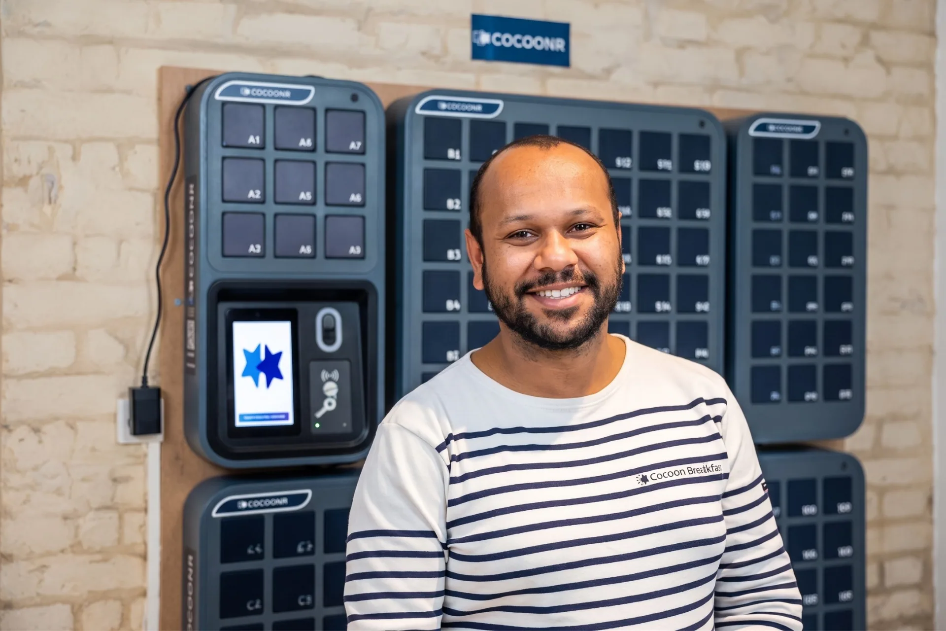Cocoonr manager standing in front of smart key box storage system