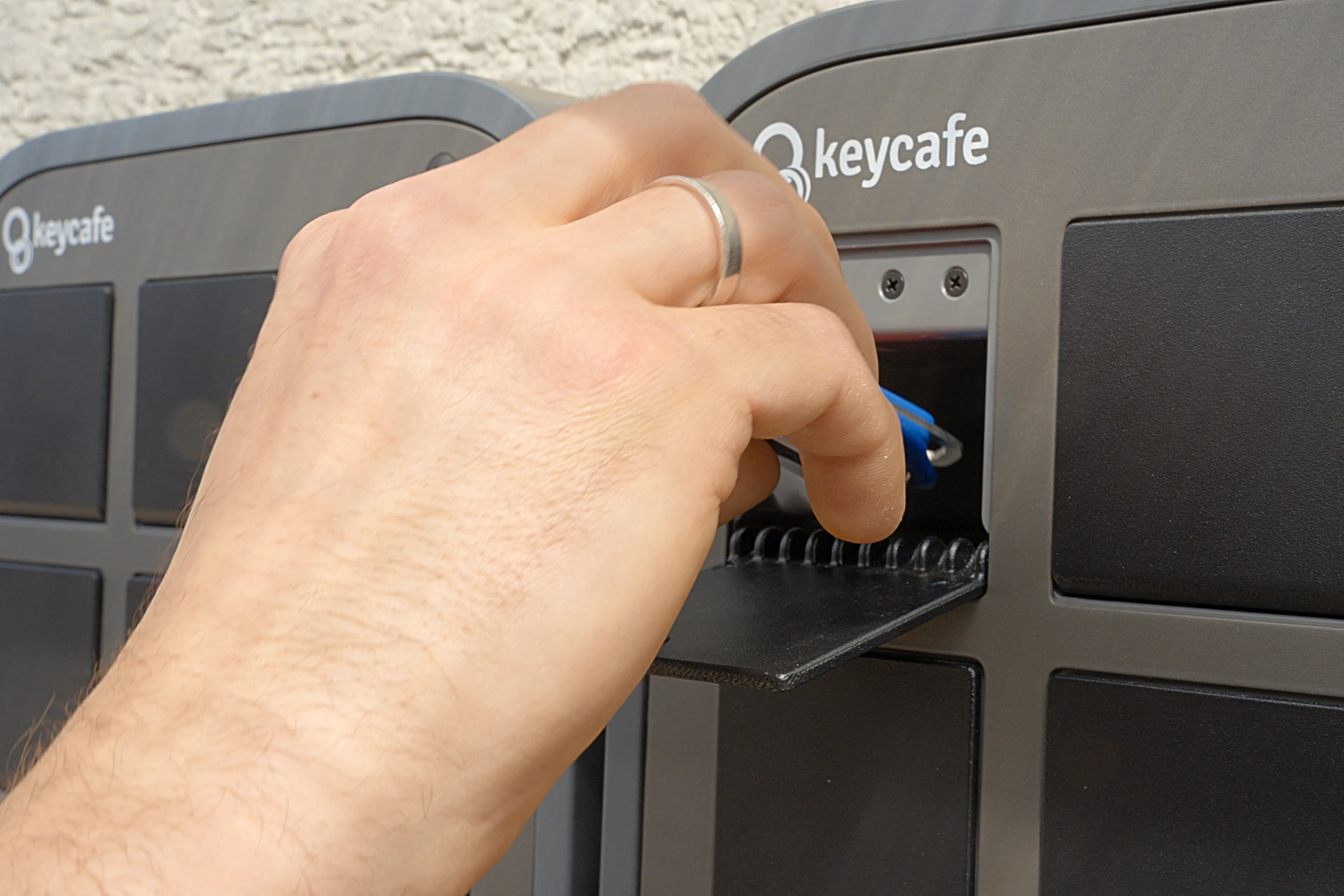 Close up of a hand taking keys from a SmartBox bin