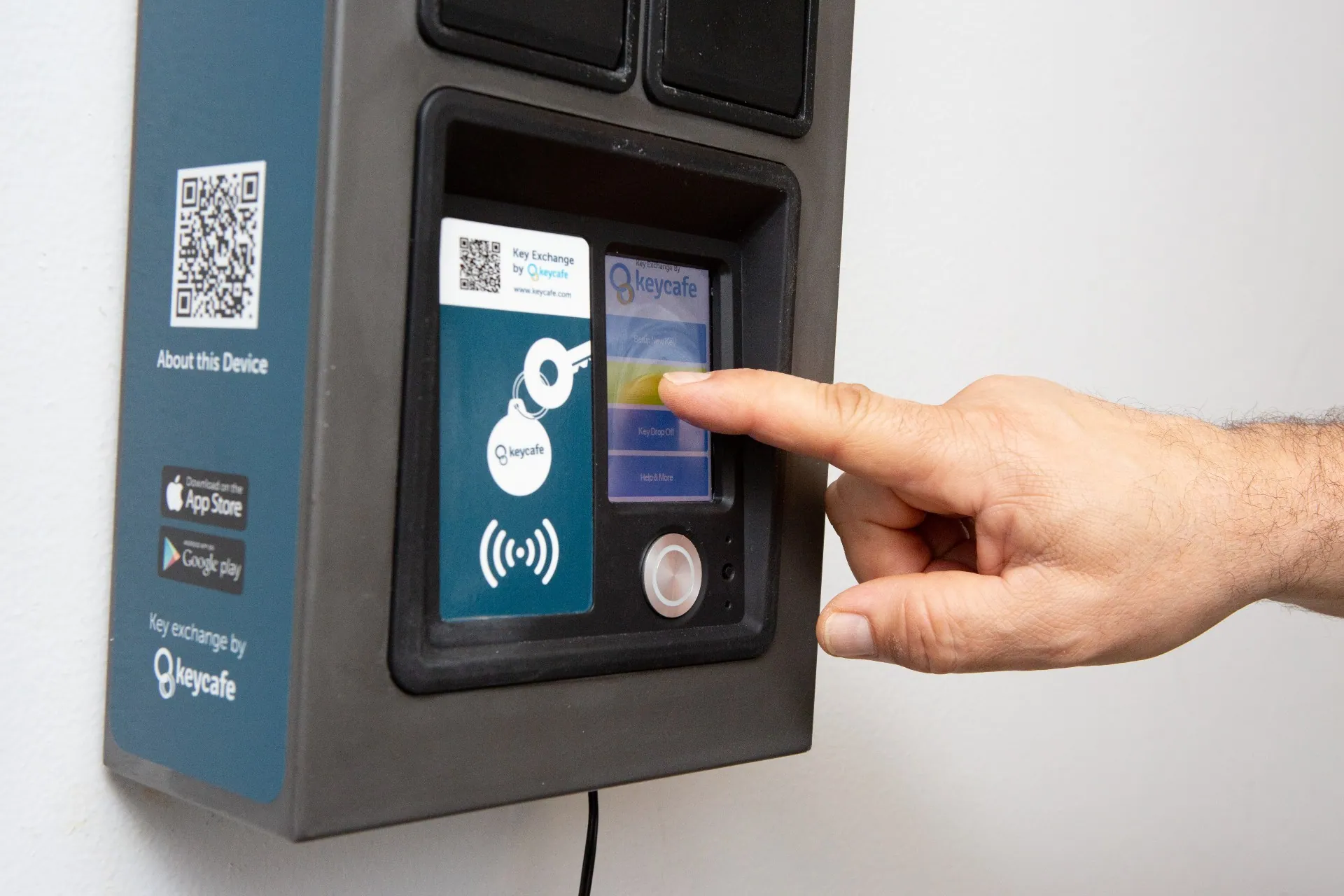 Close up of a hand tapping the Keycafe SmartBox screen