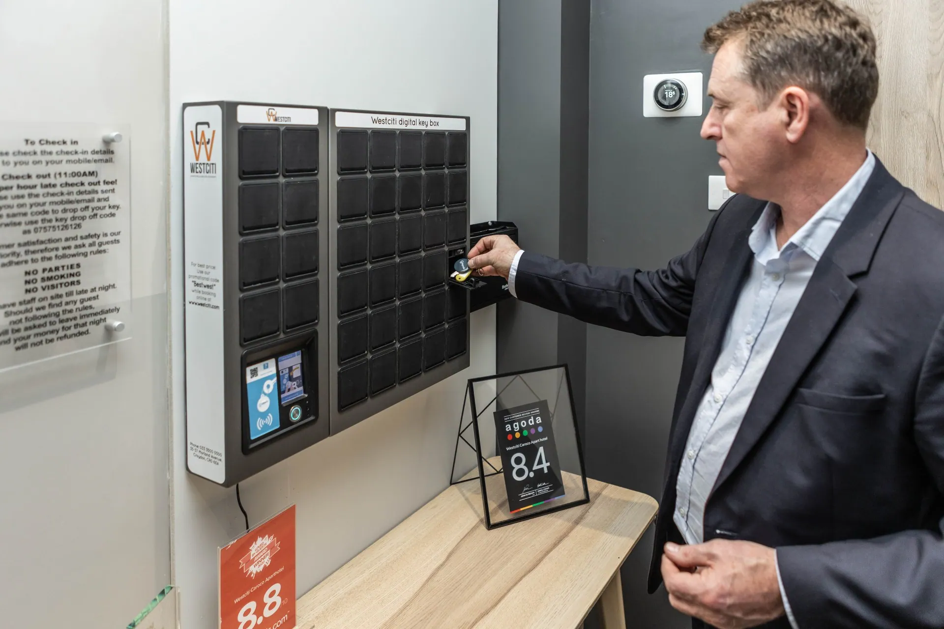 A guest placing keys into an open SmartBox bin