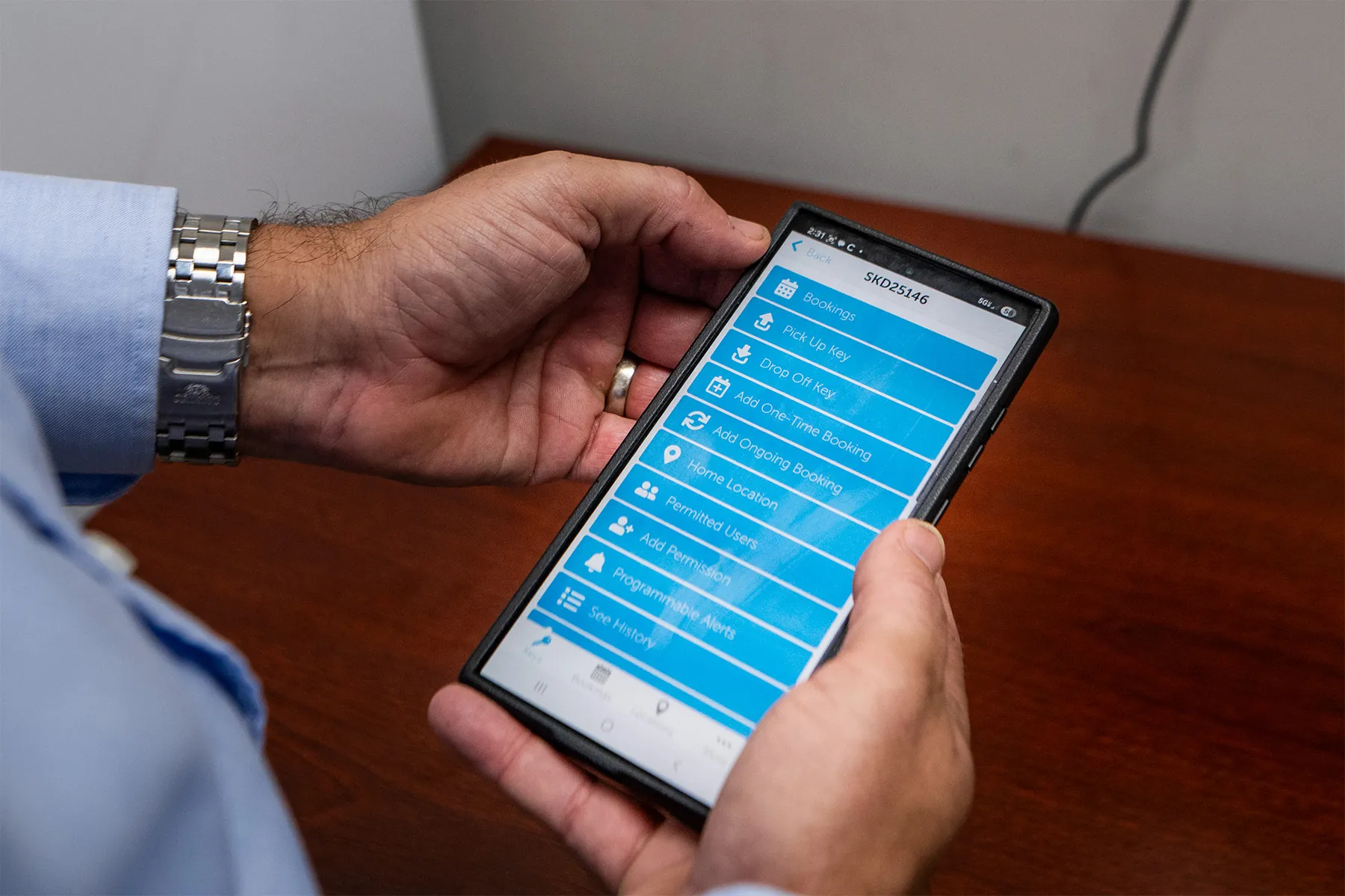 Close up of James Wolfram using the Keycafe mobile app