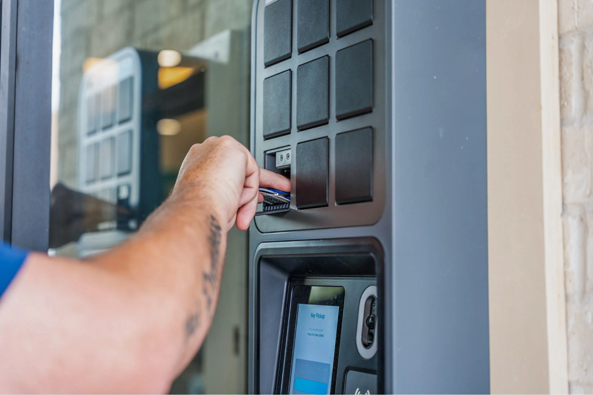 Close up of a Lodgeur guest taking keys from a SmartBox bin