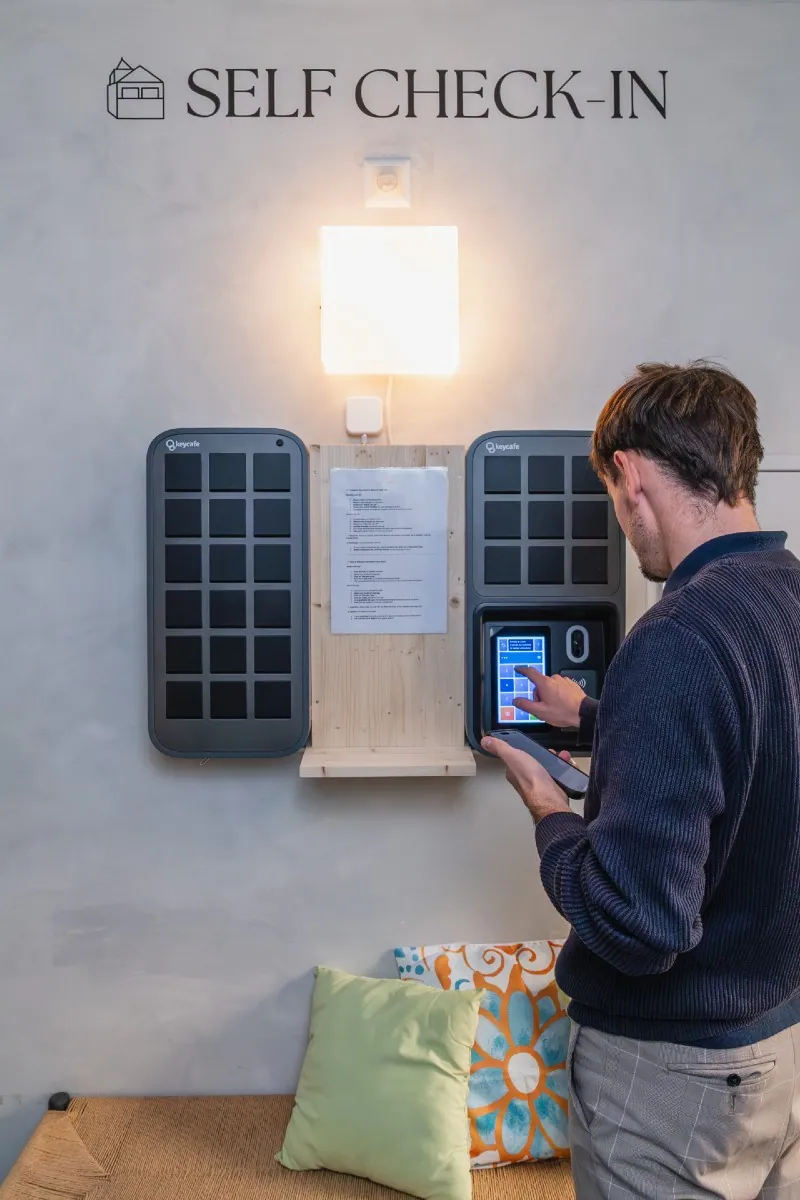 Ospite dell'hotel che digita un codice PIN alle SmartBoxes nella hall dell'Hôtel de la Poste.