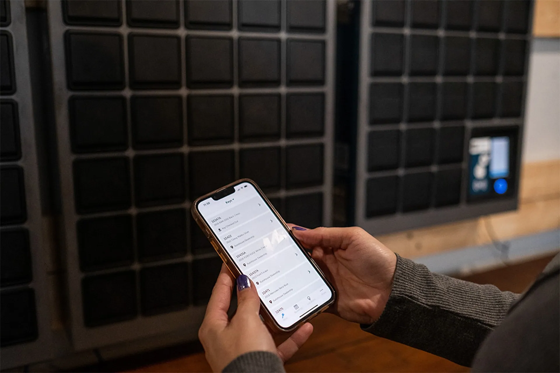 Close up of a staff member looking at a list of keys on the Keycafe mobile app