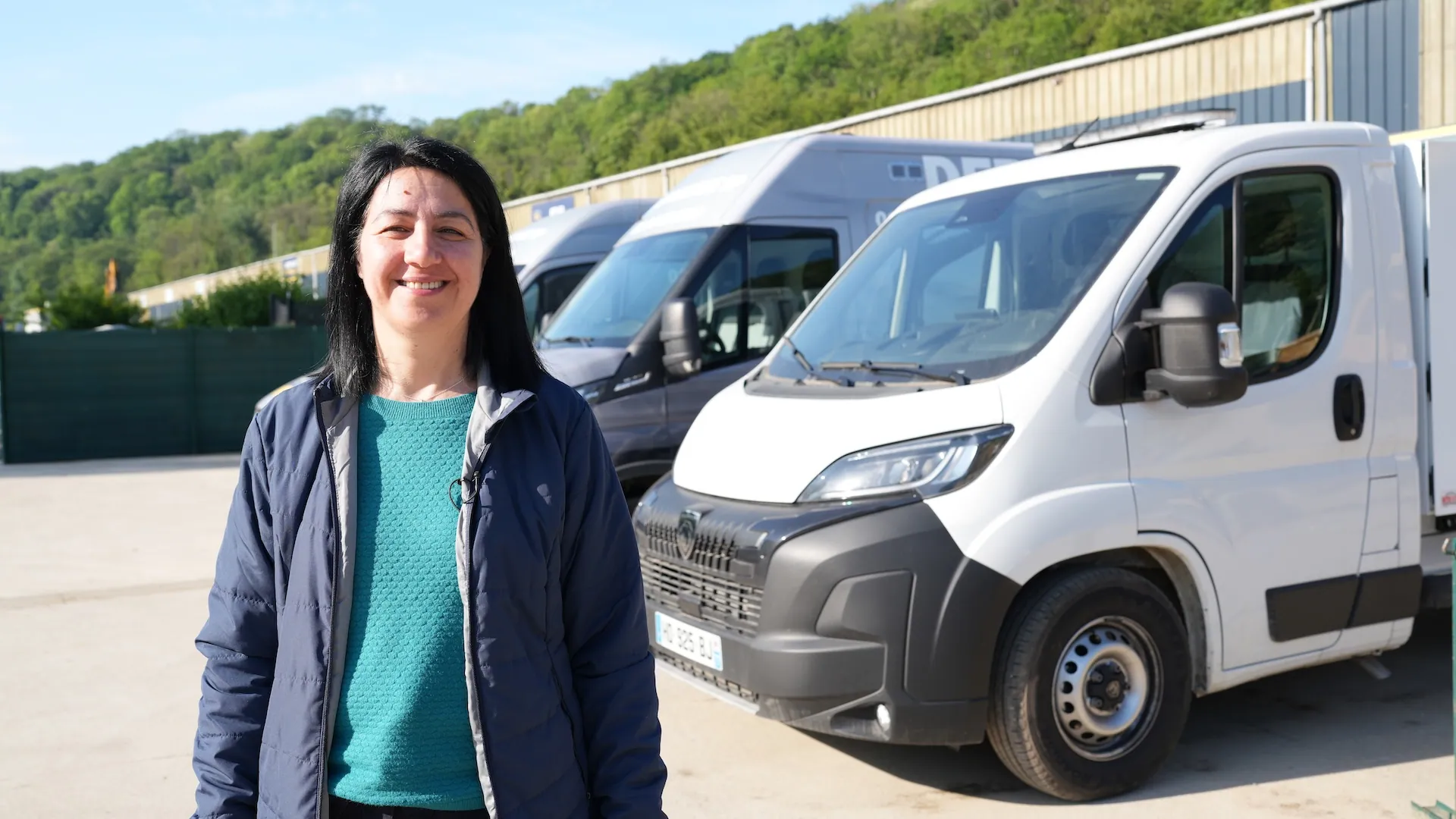 a woman standing next to a truck fleet