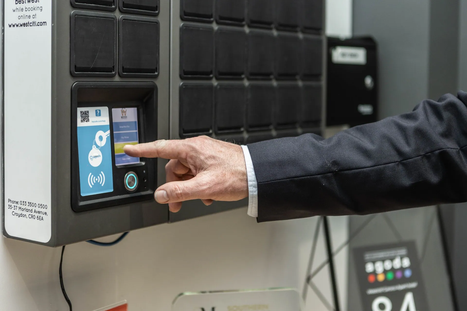 Close up of a hand tapping the SmartBox screen