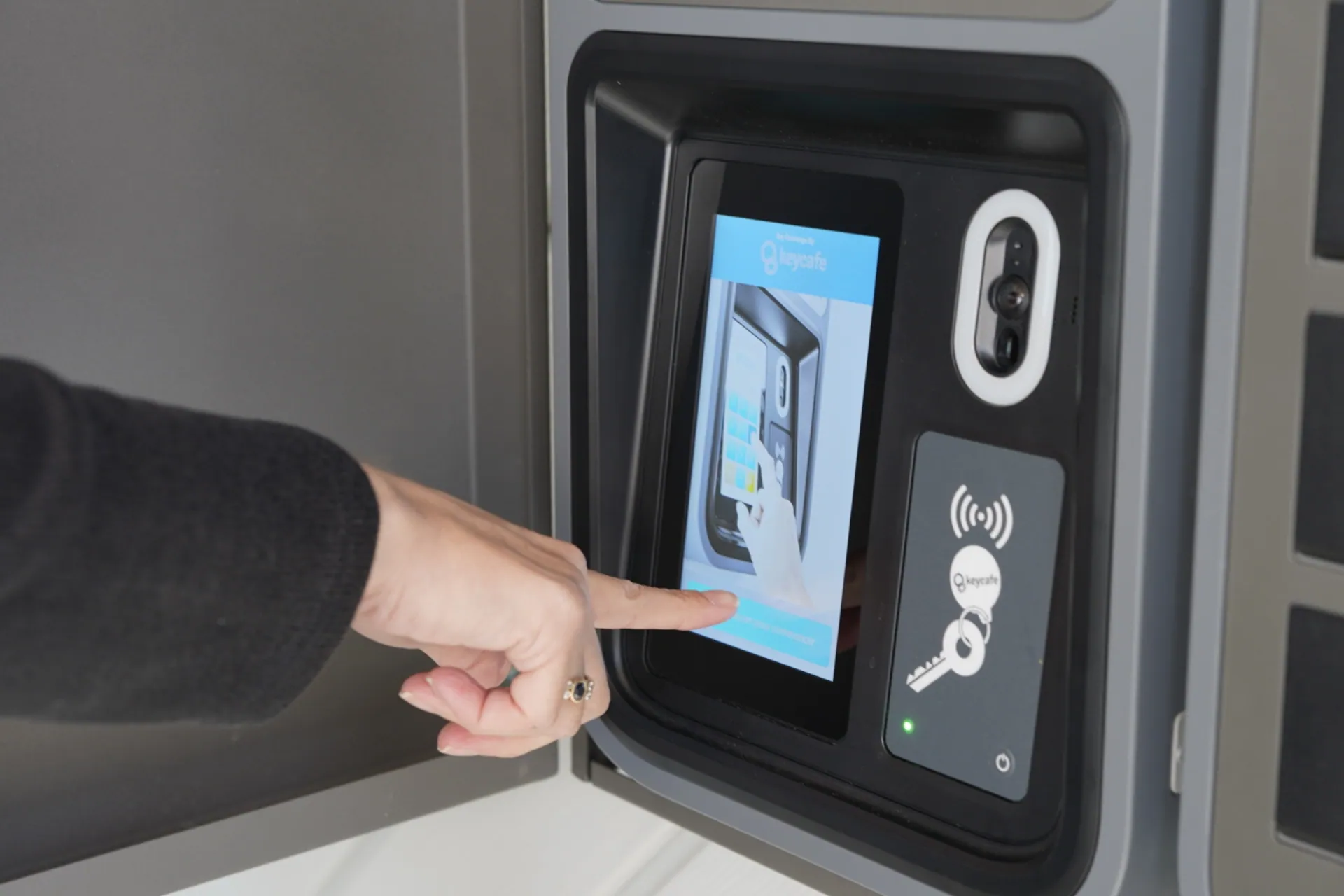 Close up of a hand tapping a SmartBox screen