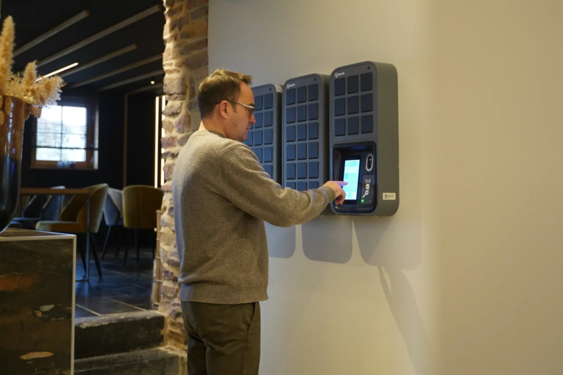 Man operating a smart locker touchscreen