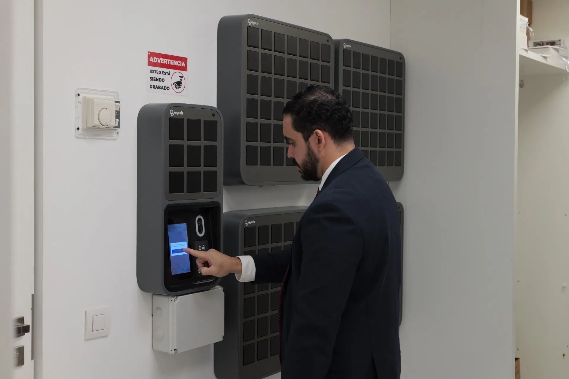 Engel & Völkers staff member tapping the SmartBox screen