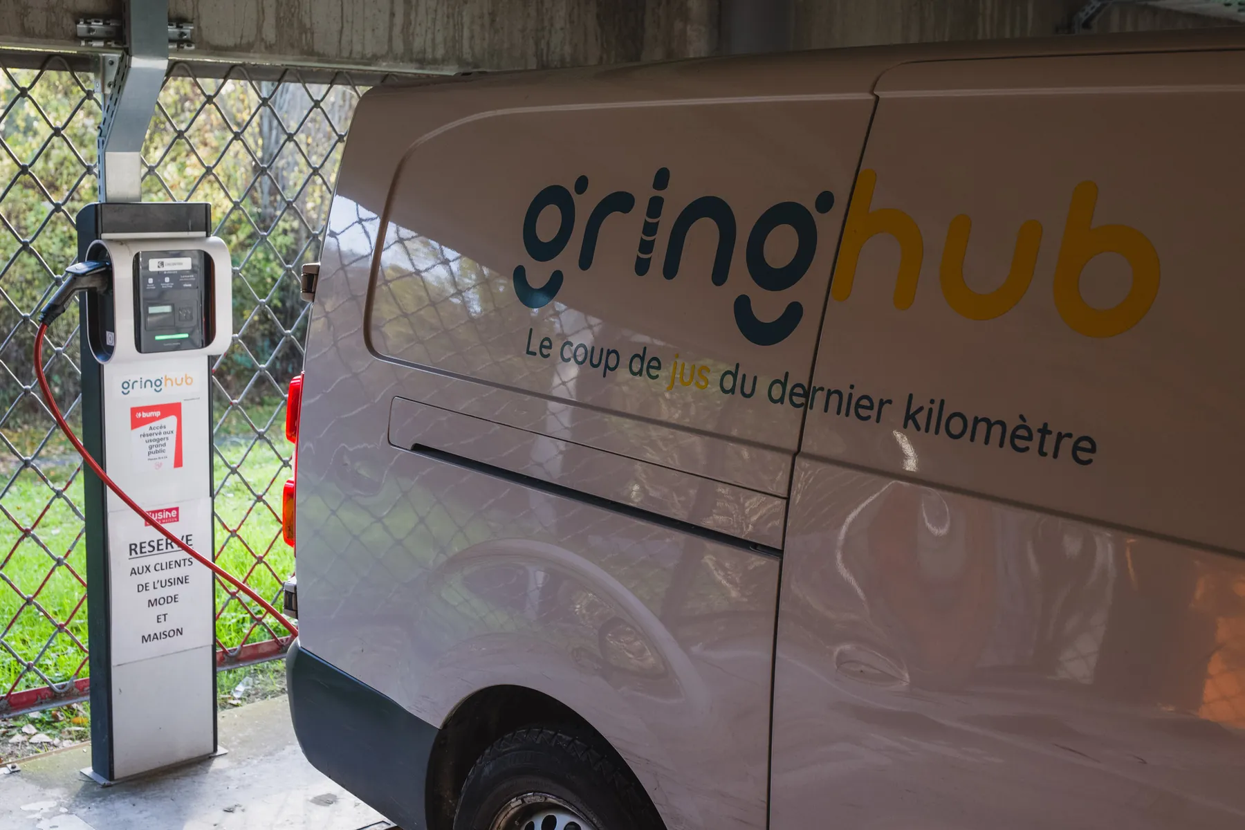 Gringhub-branded vehicle at a charging station