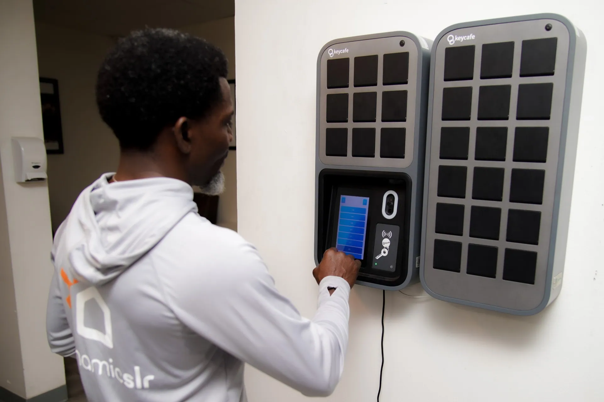 Dynamic SLR staff member selecting a key at the SmartBox screen