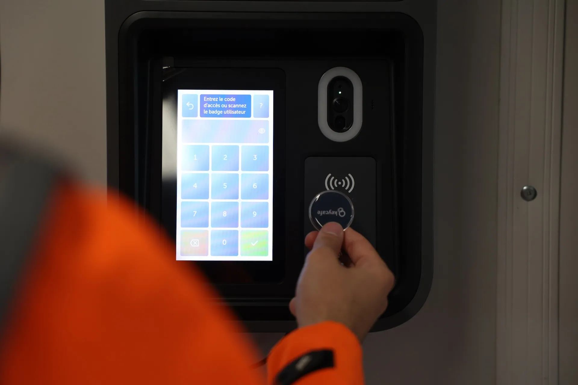 A construction worker scanning a Keycafe fob at a SmartBox