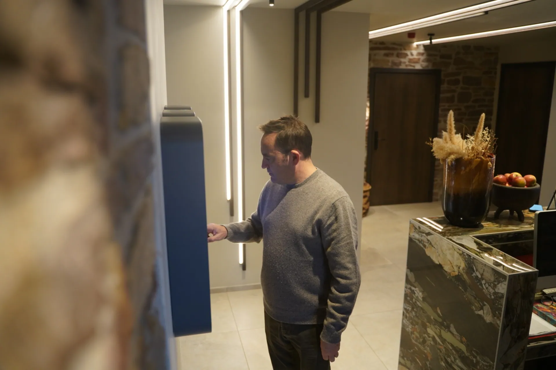 Man using the touchscreen panel on a smart locker