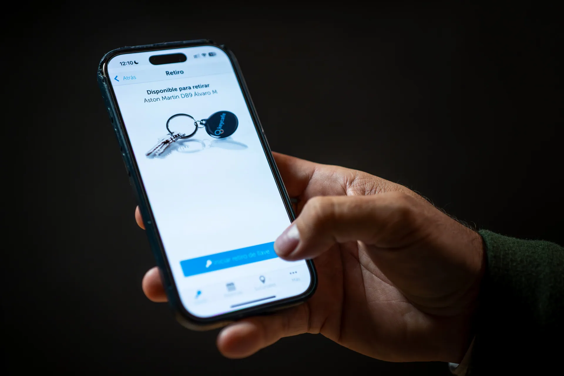 Close up of a hand holding a phone with the Keycafe app