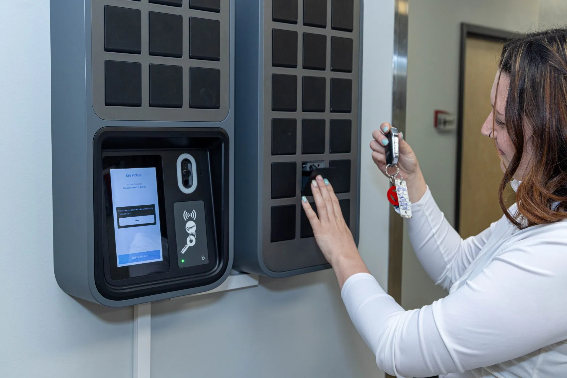Signarama employee holding keys while closing a SmartBox bin
