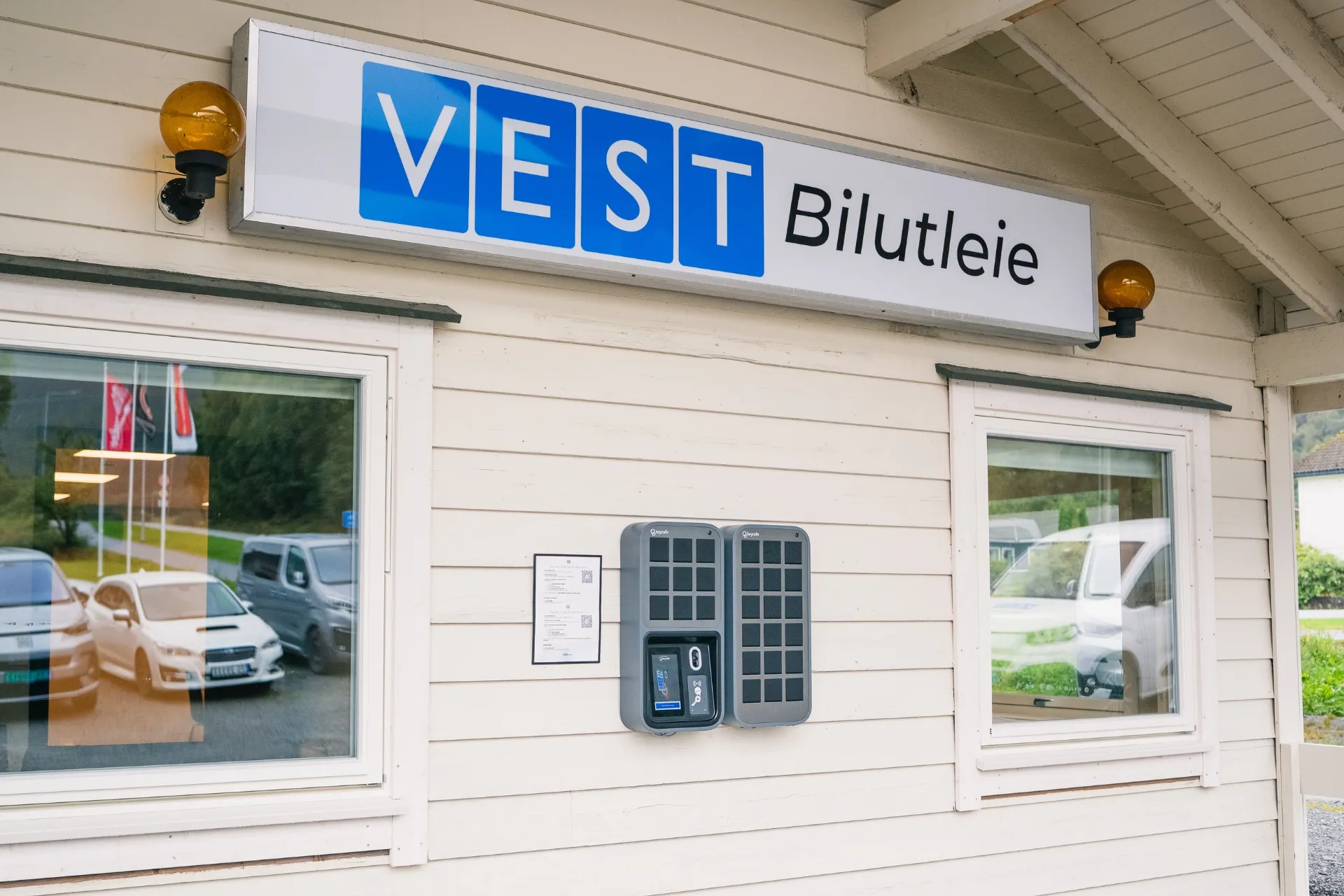 Keycafe locker system mounted on the exterior wall of the Vest Bilutleie office