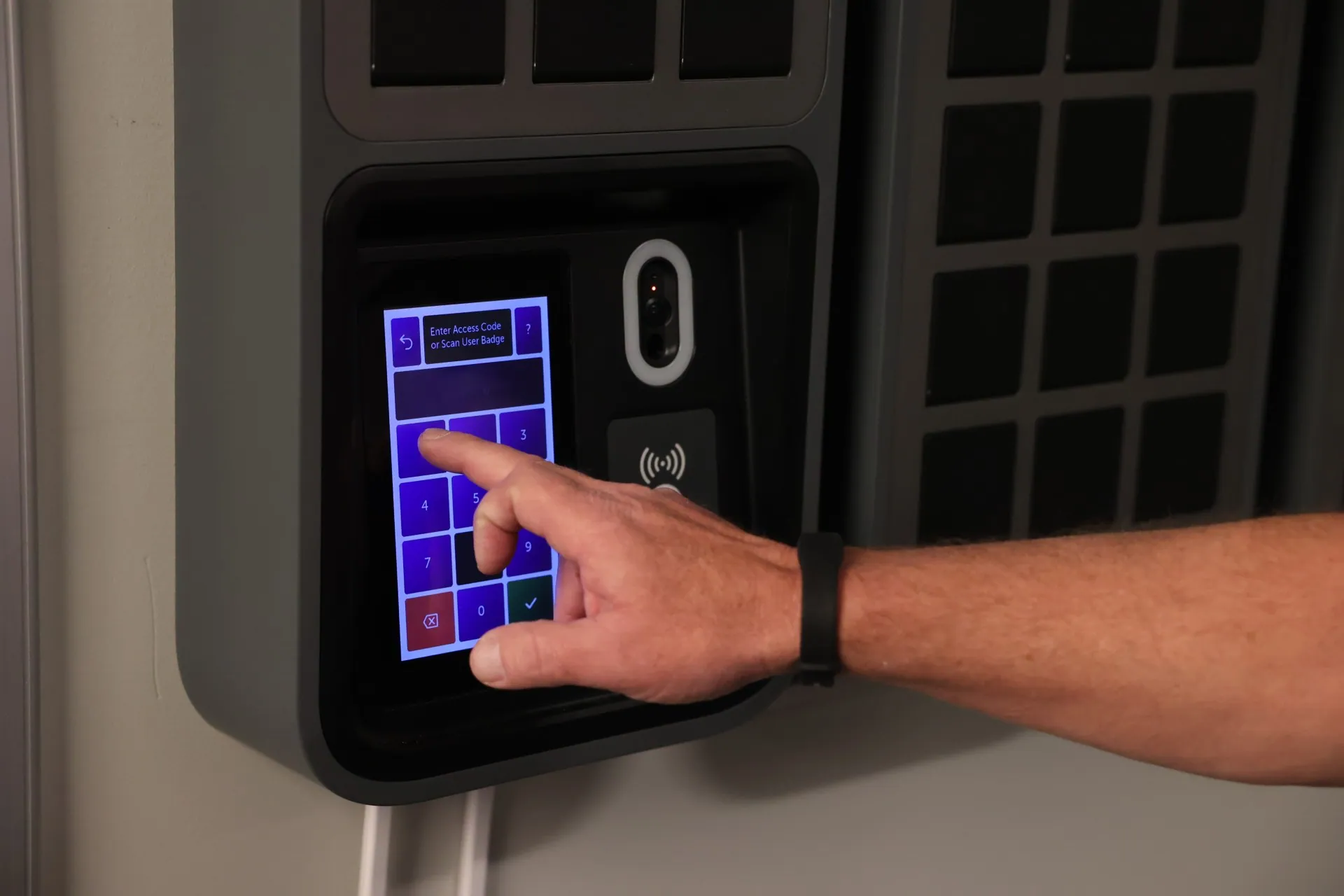 Close up of a staff member entering their PIN code at the SmartBox screen