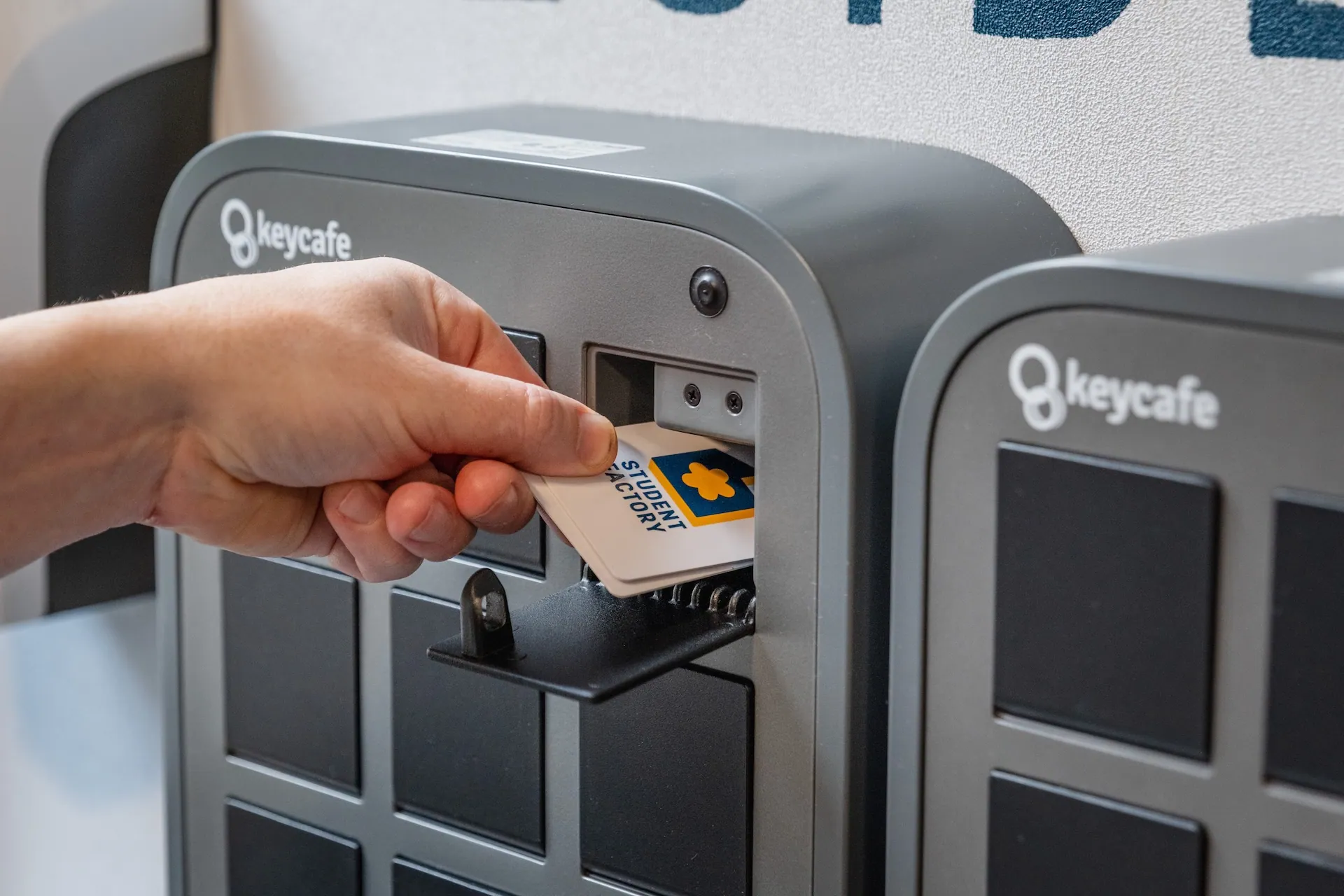 Close up of a hand placing a keycard into a SmartBox bin