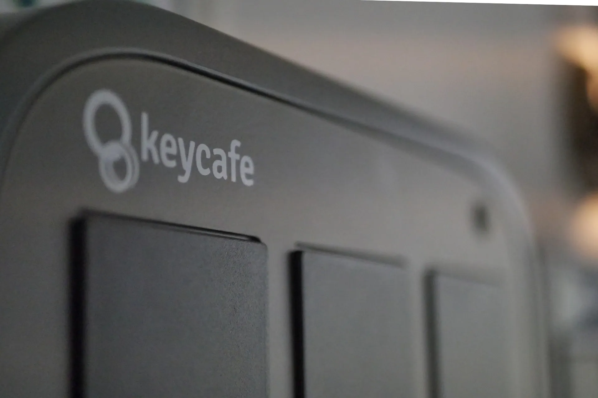 Keycafe smart key box unit showing key storage compartments and branding.