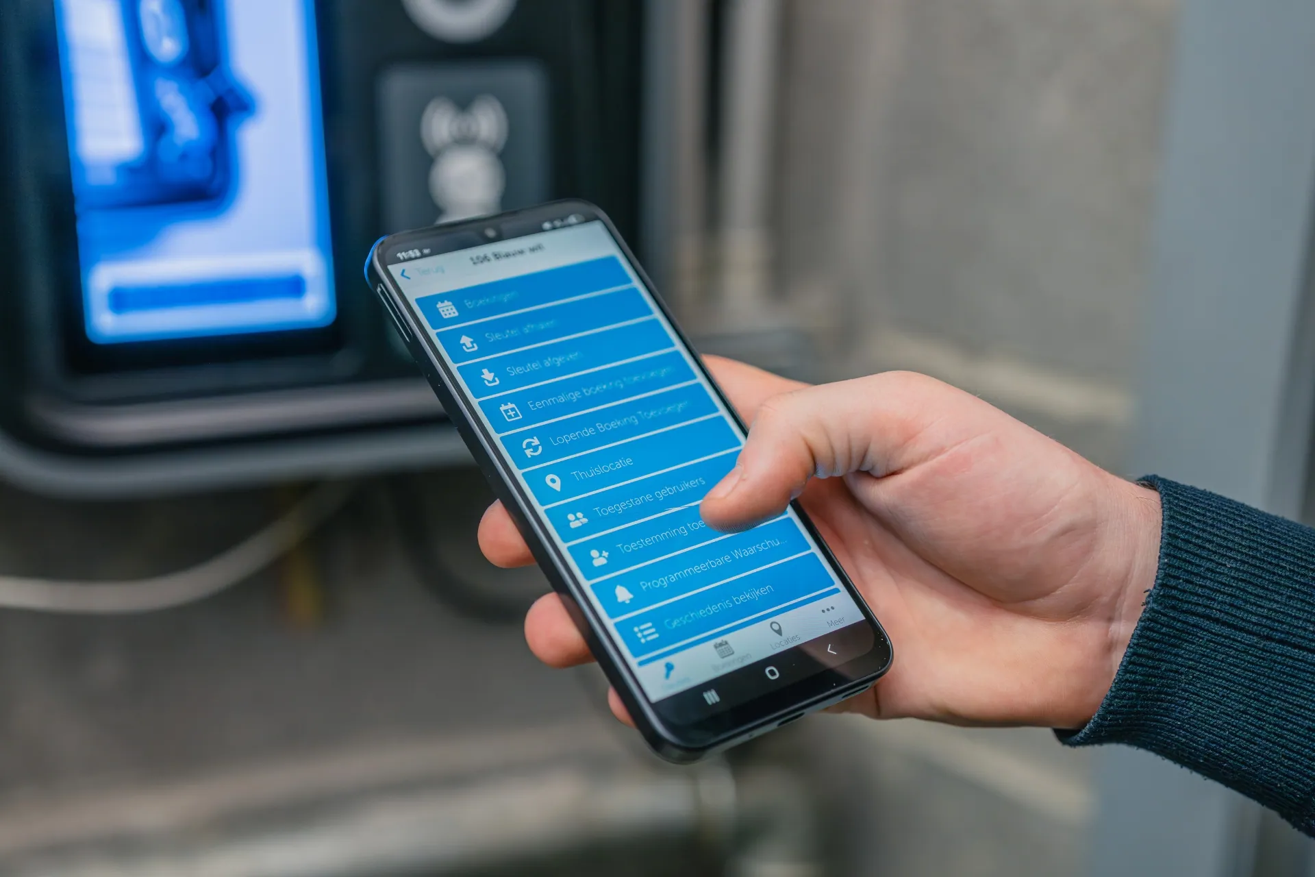 Hand holding a phone with the Keycafe app open