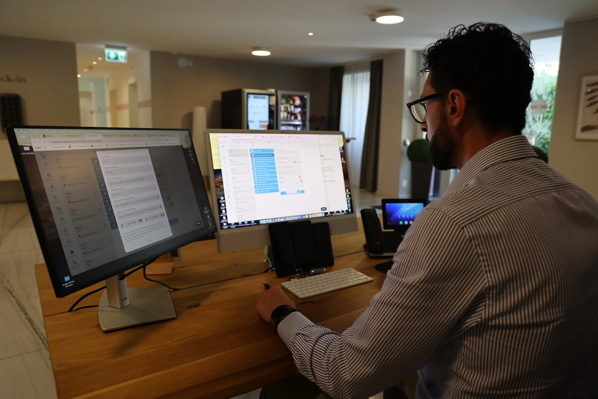 Antonio Coppola looking at the Keycafe dashboard at the reception desk computer