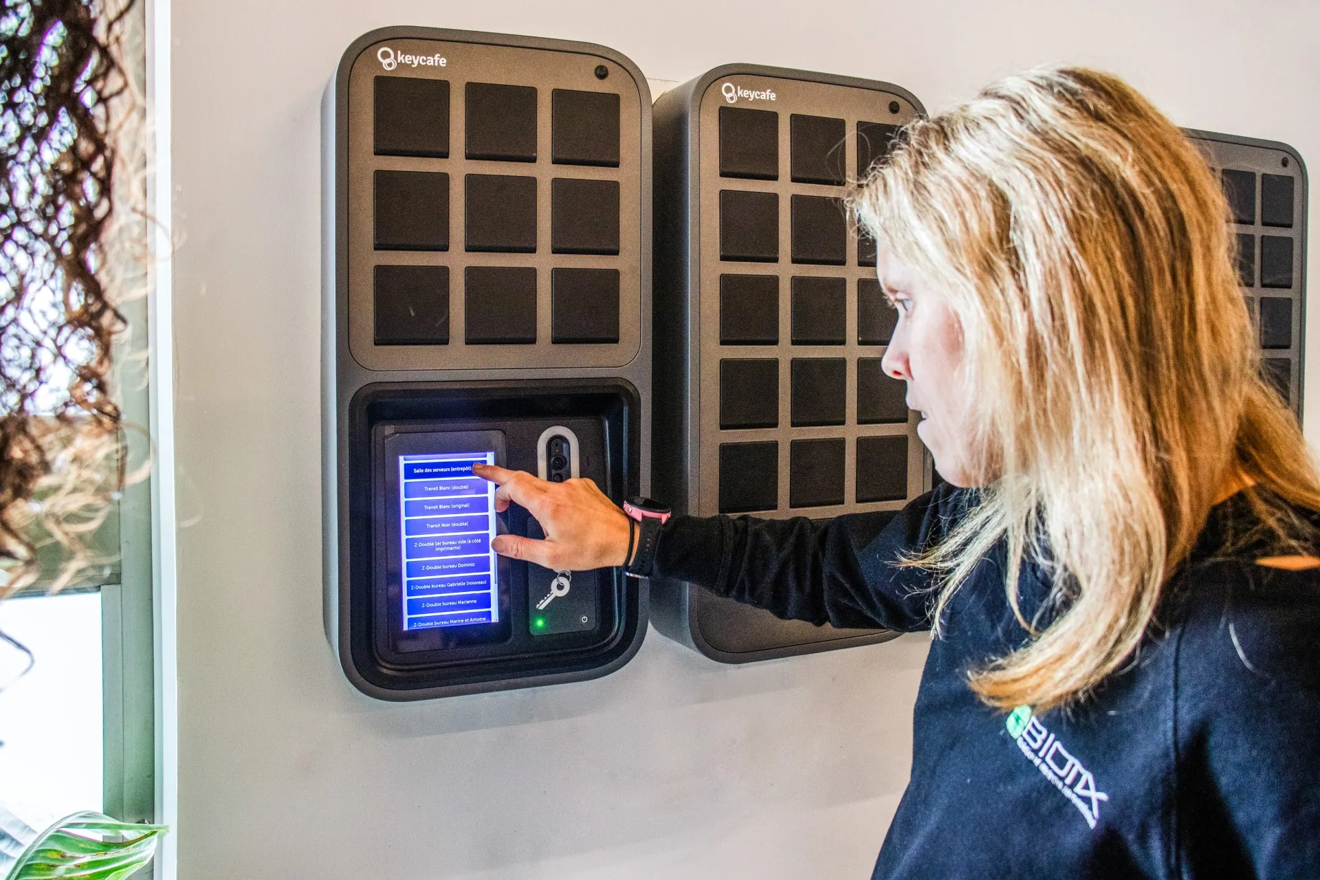 Biotix Environmental Solutions employee scrolling through a list of keys on the SmartBox screen