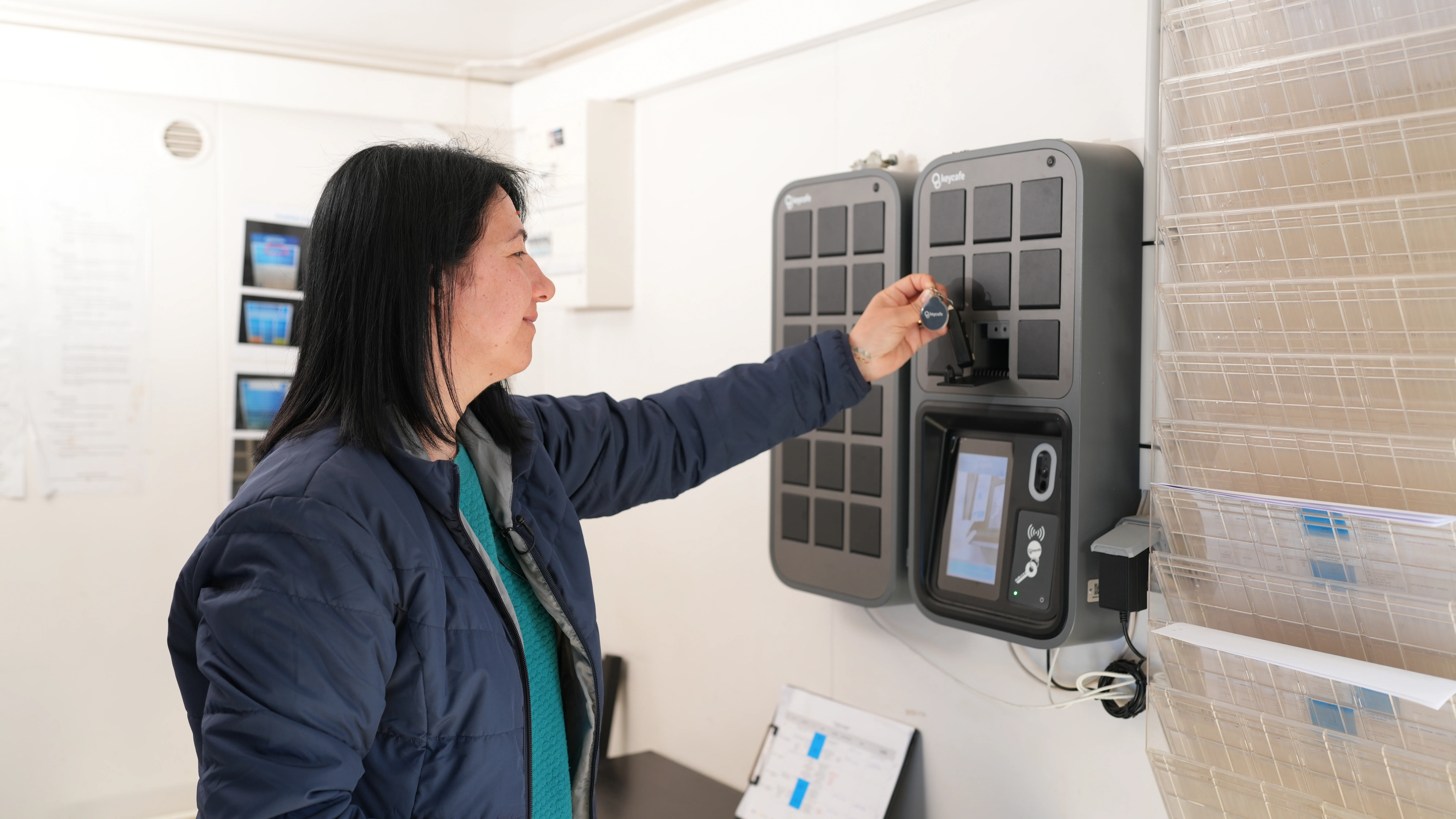 a woman picking up a key from the keycafe smartbox