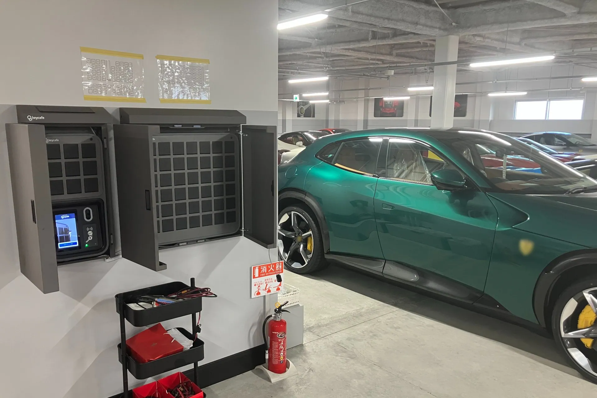 Wall-mounted SmartBoxes inside a garage full of Italian luxury vehicles