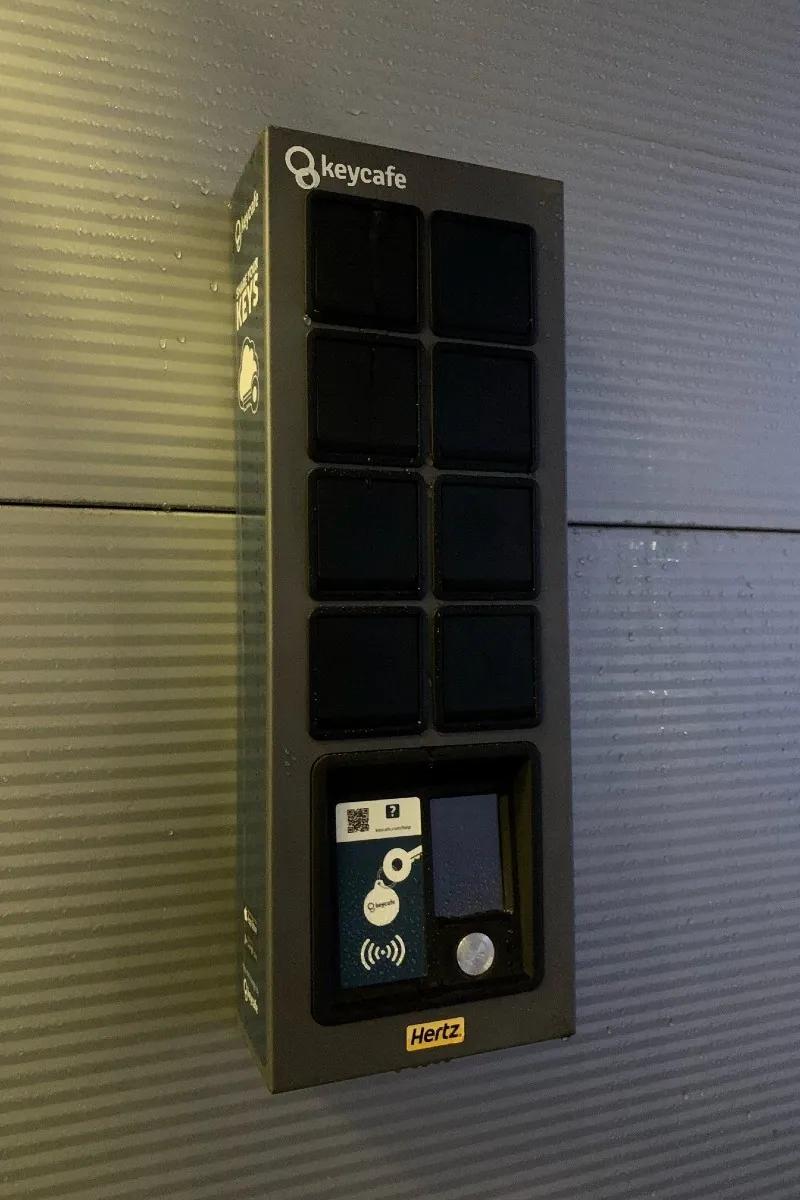 A Keycafe SmartBox wall-mounted at a Hertz rental location