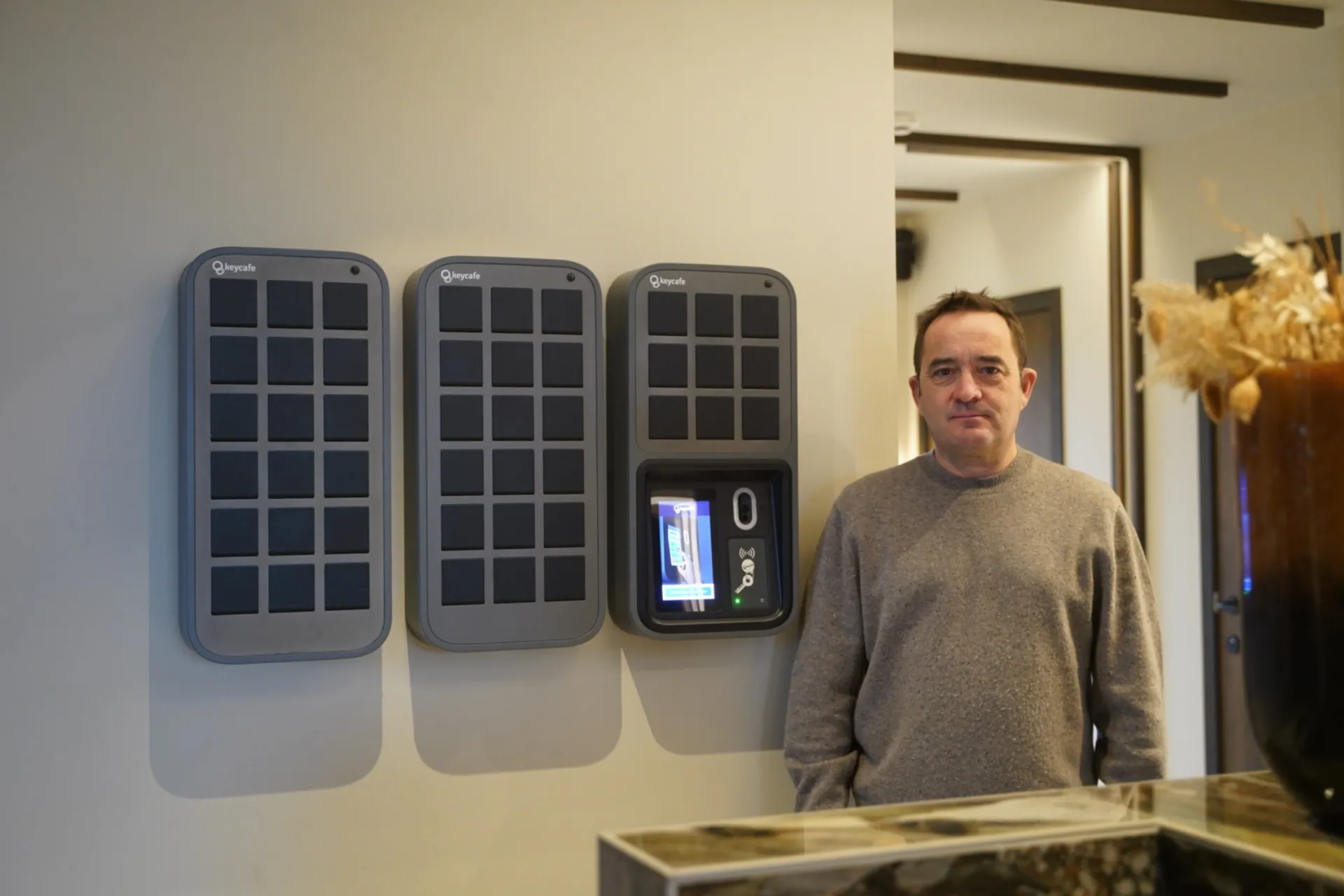 Man standing next to a smart key locker system