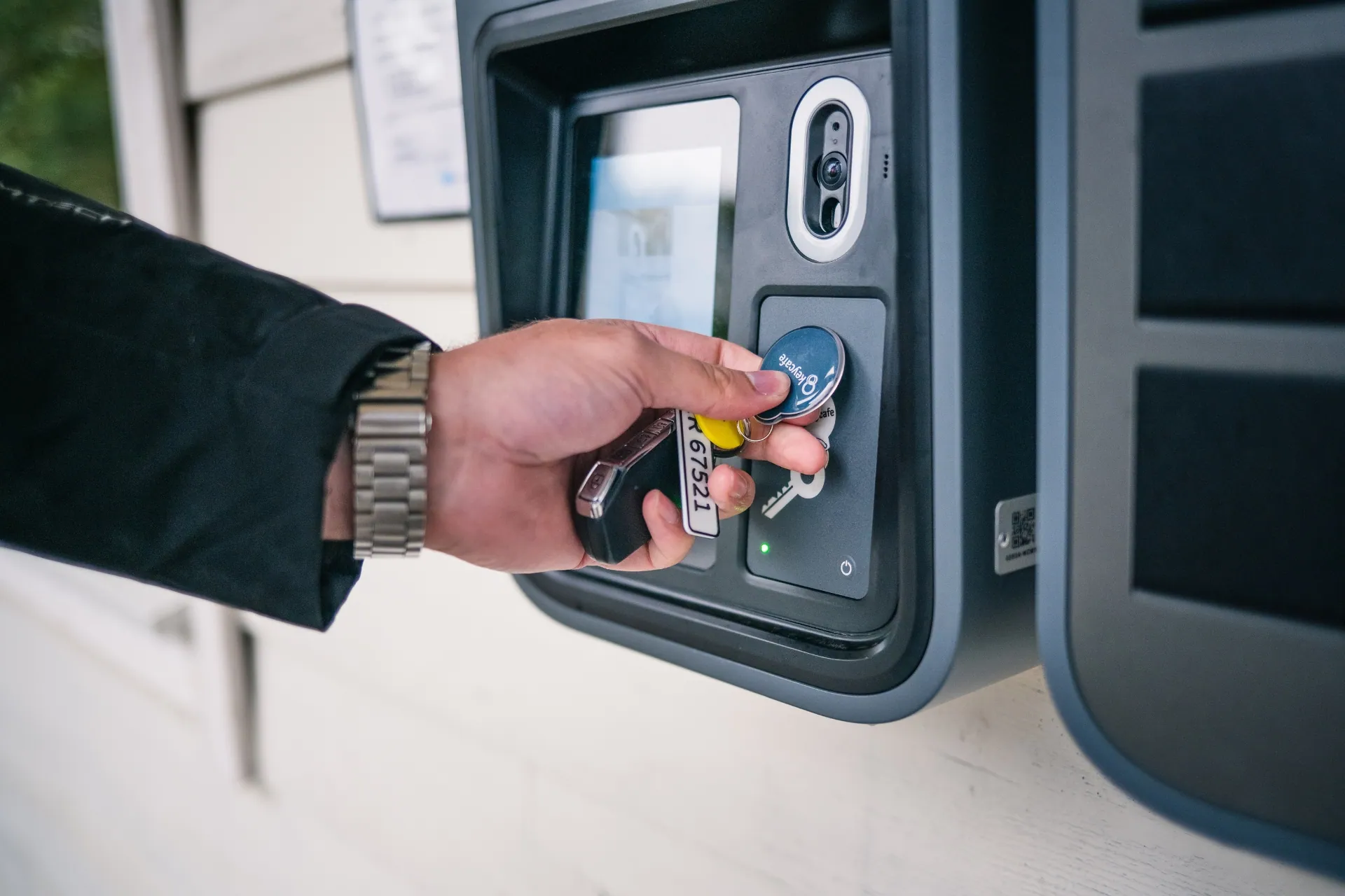 Close-up of person scanning a Keycafe key fob in order to drop it off