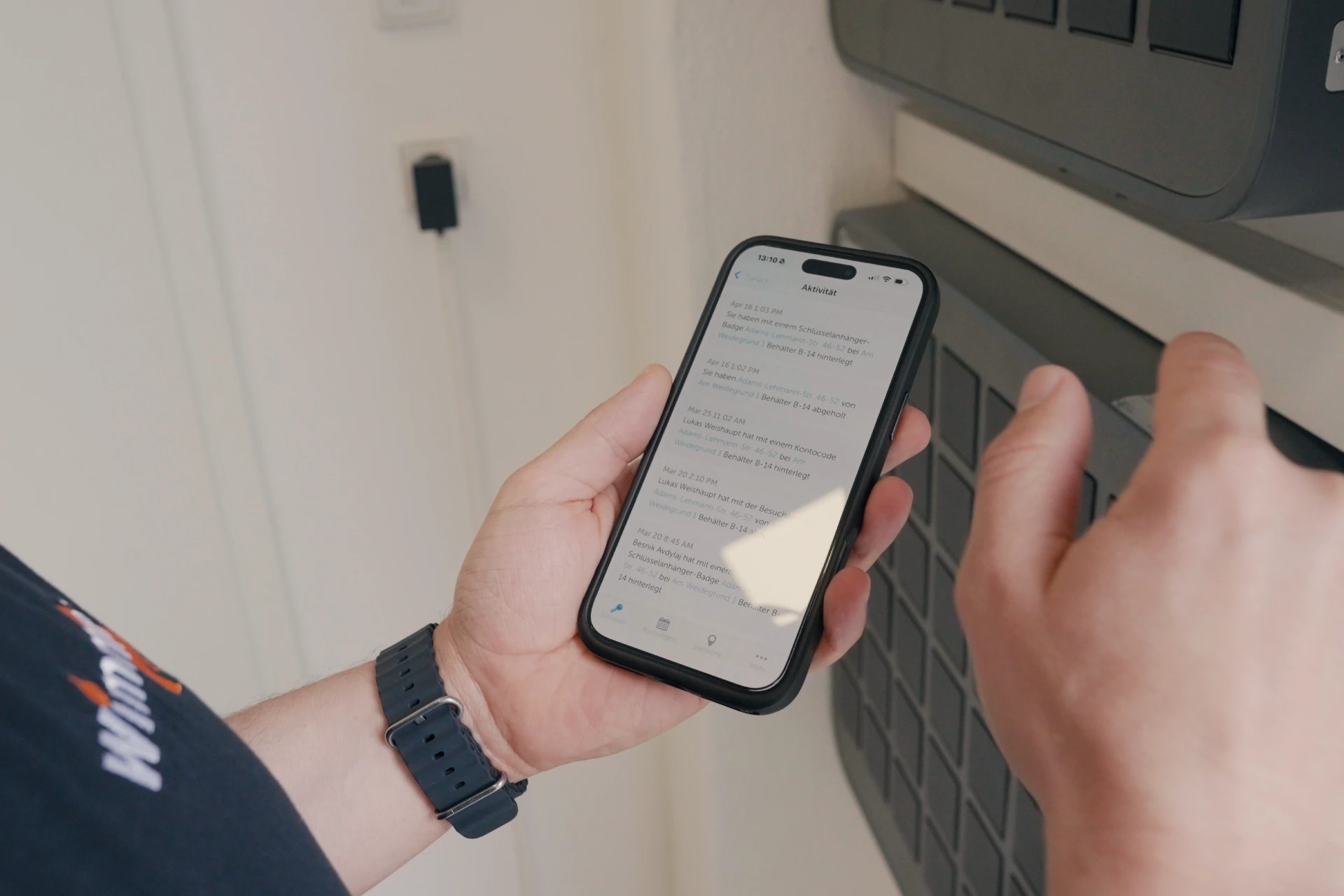 Close up of Tobias Wimmer using the Keycafe app on a mobile phone
