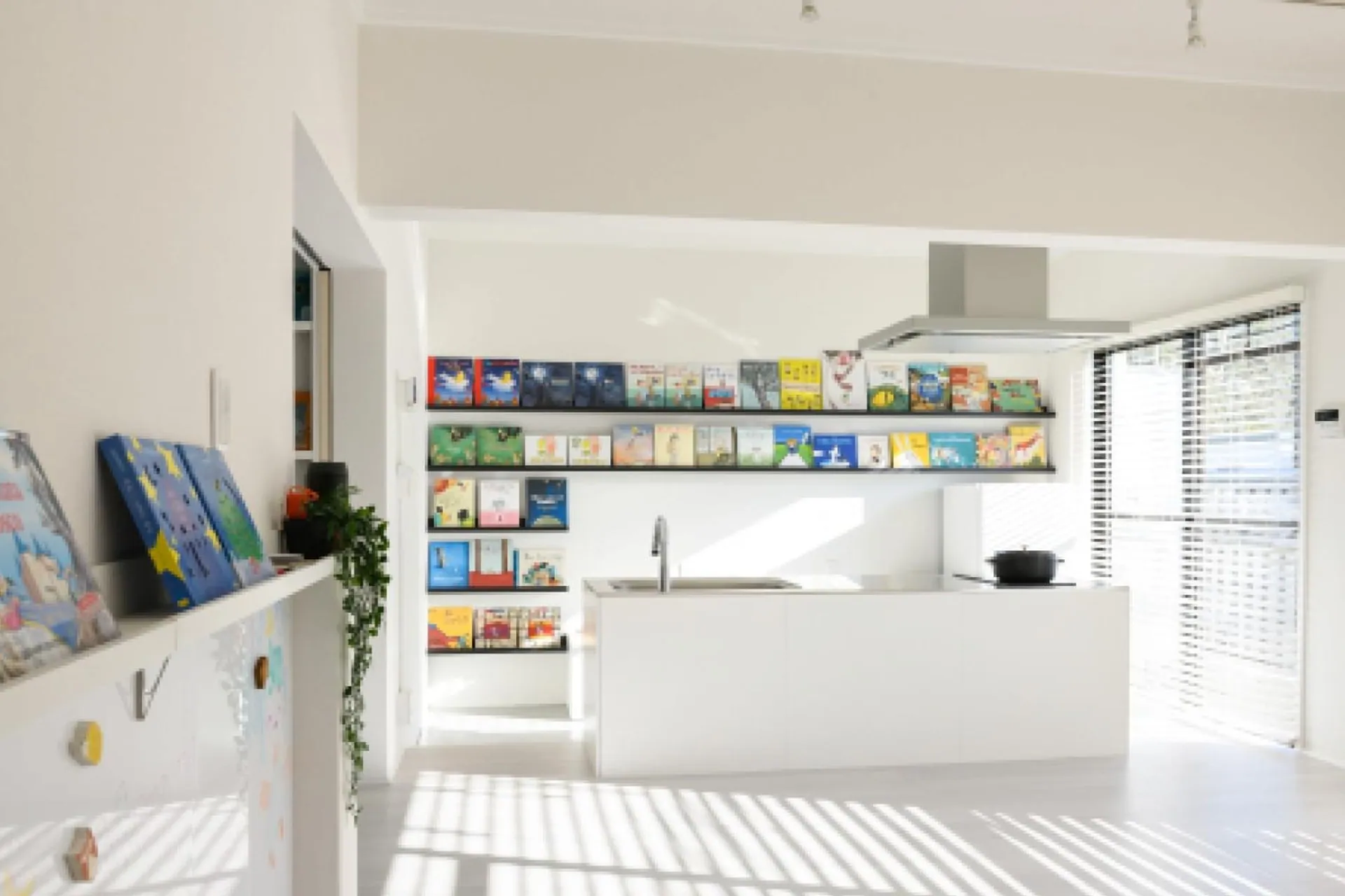 Bookshelves with children's books inside an Ehon Hotel room