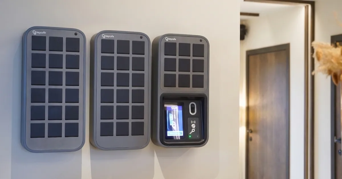 Keycafe smart key management system and key lockers mounted on a wall for automated property check-ins.