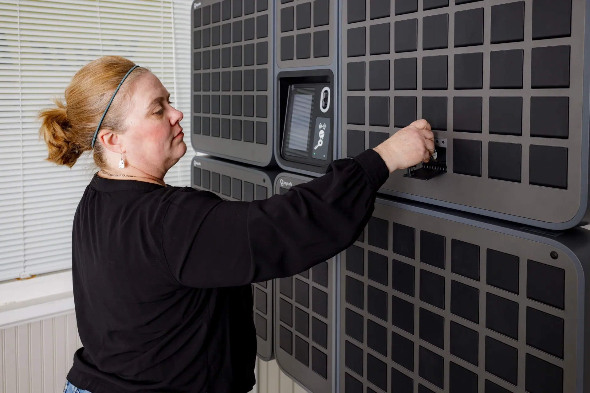 Your Place Property Management employee placing a key into a SmartBox bin