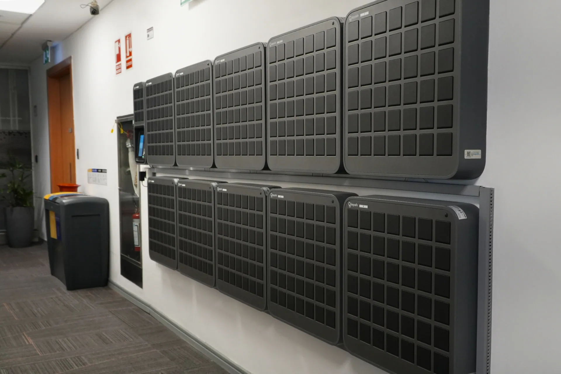 A large Keycafe SmartBox system setup for 429 keys mounted on an airport hallway wall