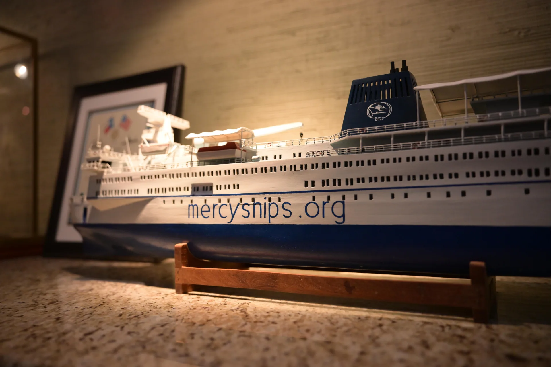 A large model of a cruise ship on display indoors.