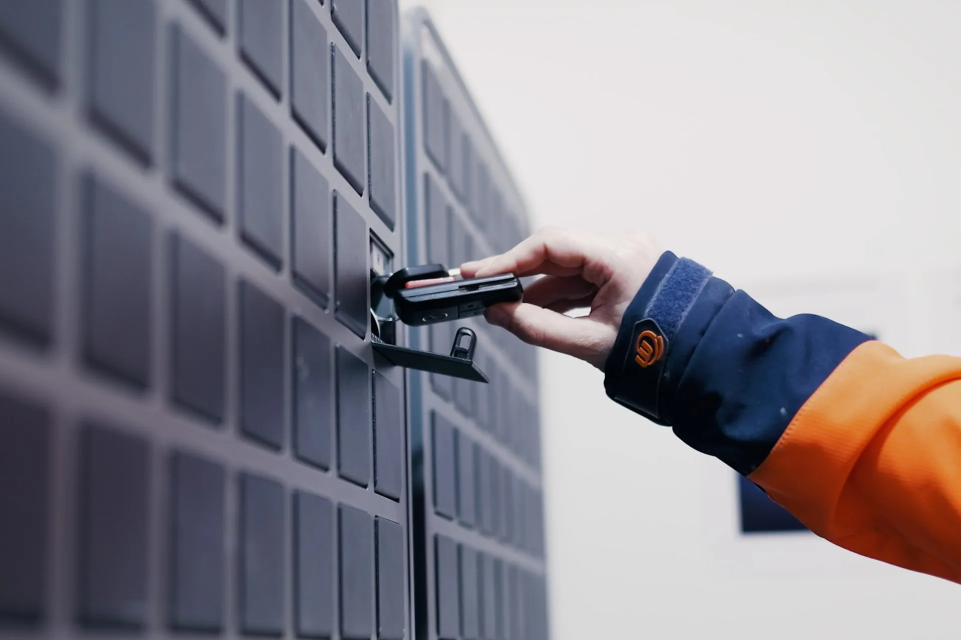 Close up of placing a vehicle key in a SmartBox bin