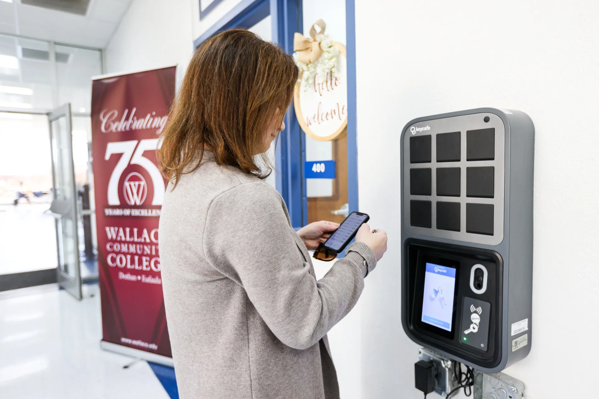 Student and Campus Services Specialist Laurel Rasberry using the mobile Keycafe app beside the SmartBox