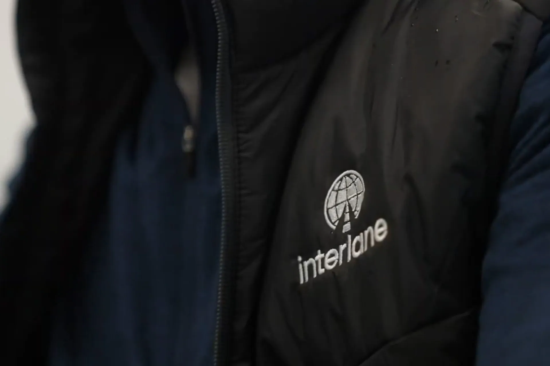 Close up of the Interlane Car Transport logo on an employee vest