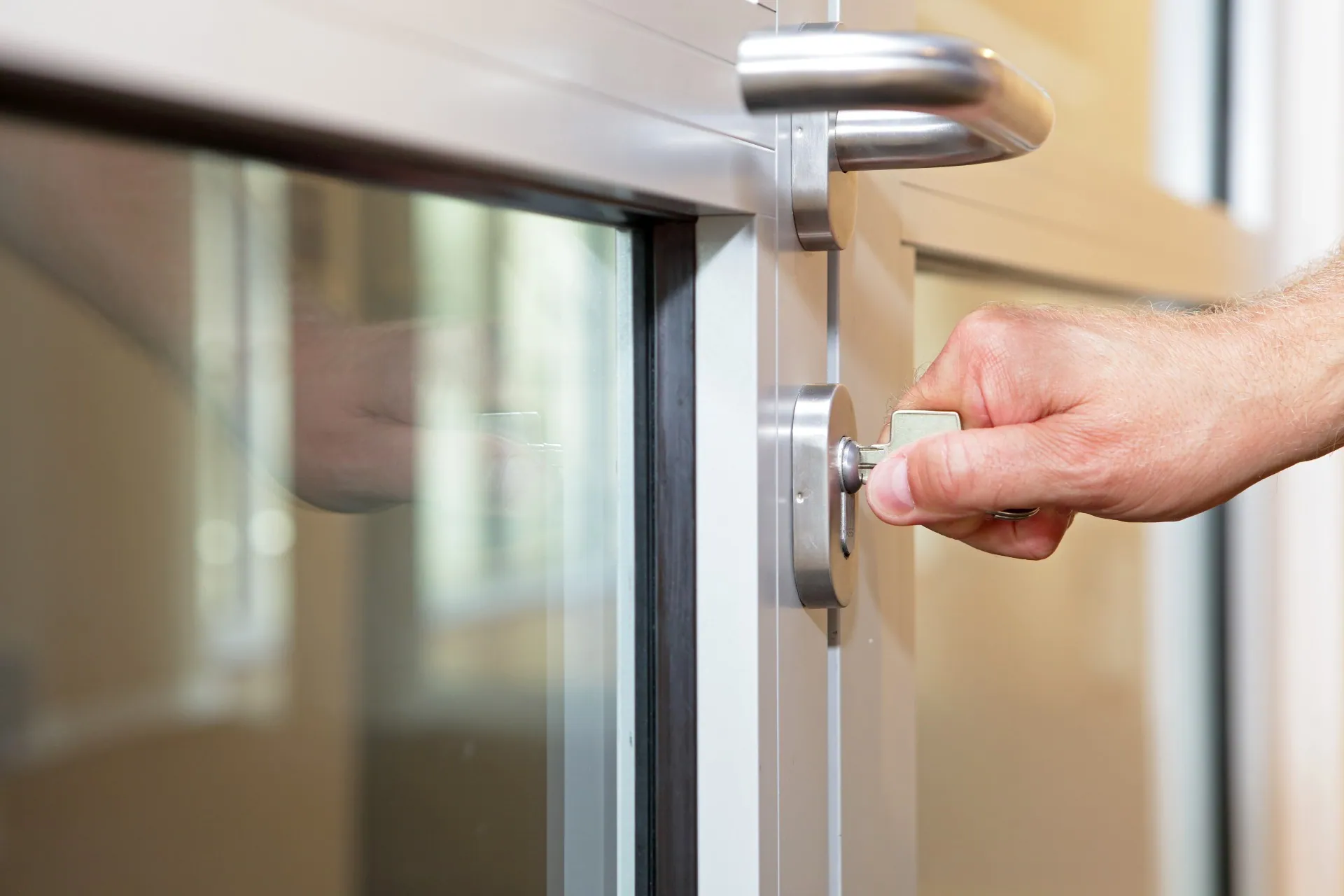 Close-up of someone unlocking a door with a key