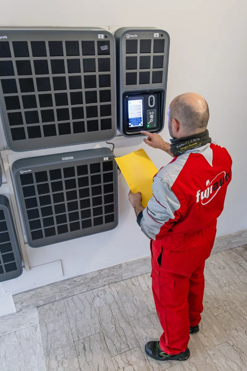 A Fuji Auto service technician tapping a SmartBox screen